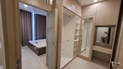 Spacious bedroom with large windows, built-in closet, and dressing table