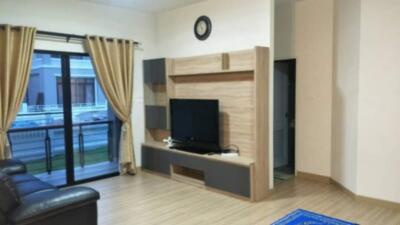 Modern living room with entertainment center and balcony view