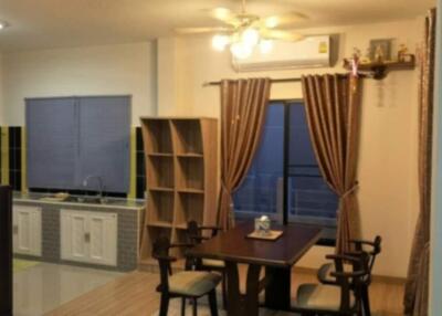 Dining area with kitchen in the background