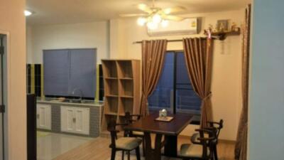 Dining area with kitchen in the background