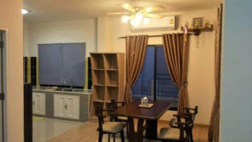 Dining area with kitchen in the background