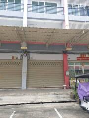 Front view of a commercial building with shutter doors