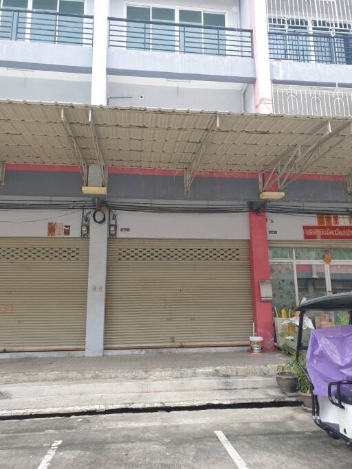 Front view of a commercial building with shutter doors