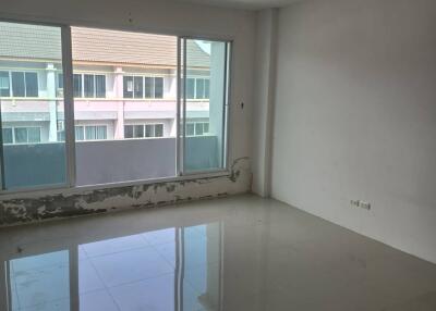 Unfurnished room with large window and tiled floor