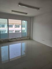 Unfurnished room with large window and tiled floor