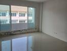 Unfurnished room with large window and tiled floor