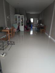 Main living area with chairs, a cabinet, and some clutter