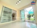 Bright and spacious living room with large windows leading to garden area