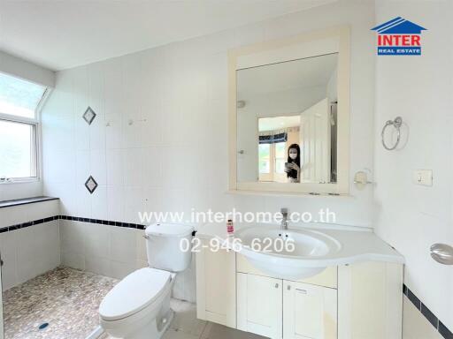 Bathroom with large mirror and window