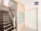 Bright hallway with staircase and door