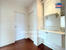 Hallway with white doors and a small built-in shelf and cabinet