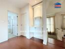 White bedroom with wooden flooring and built-in shelves