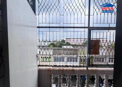 Balcony with railing and view of neighboring buildings