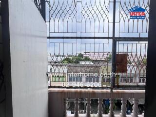 Balcony with railing and view of neighboring buildings