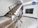 Interior staircase with wooden handrail and metal balusters