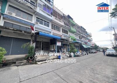 Street view of a building with multiple units and visible contact information for Inter Real Estate