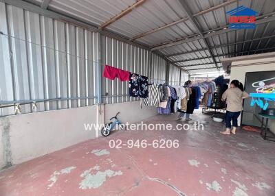 Semi-outdoor area with laundry hanging on a clothesline