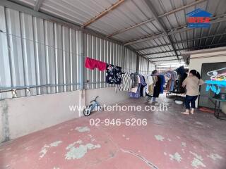 Semi-outdoor area with laundry hanging on a clothesline