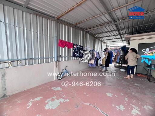 Semi-outdoor area with laundry hanging on a clothesline