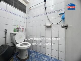 Bathroom with tiled walls and floor