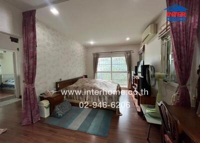 Spacious bedroom with natural light and air conditioning