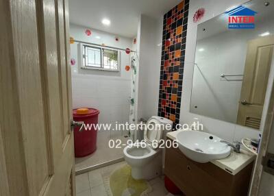 Bathroom with modern fixtures and decorative tiles