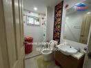 Bathroom with modern fixtures and decorative tiles