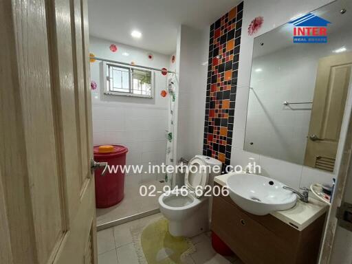 Bathroom with modern fixtures and decorative tiles