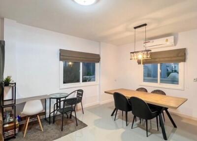 Modern dining area with a wooden table and chairs