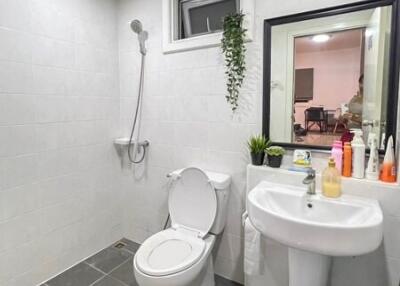 Modern bathroom with white tiles and grey flooring