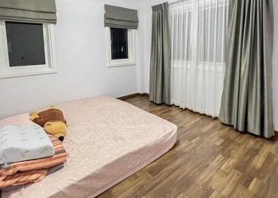 Bedroom with hardwood floor, bed, and windows