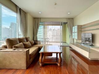 Spacious living room with a large window and city view