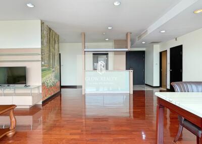 Modern living room with wooden flooring and open kitchen