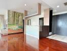 Living space with wooden flooring and forest mural