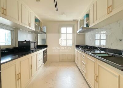 Modern kitchen with white cabinetry and black countertops