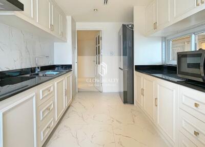 Modern kitchen with white cabinetry and black countertops