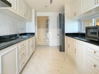 Modern kitchen with white cabinetry and black countertops