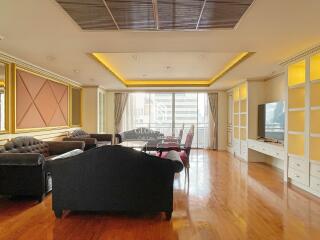 Spacious and well-lit living room with modern furniture and large windows