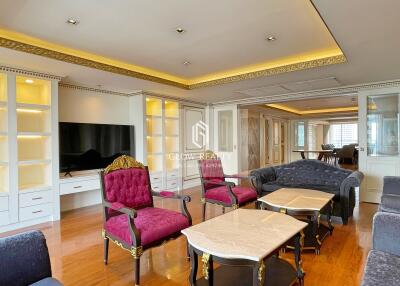 Elegant living room with ornate furniture and built-in shelving