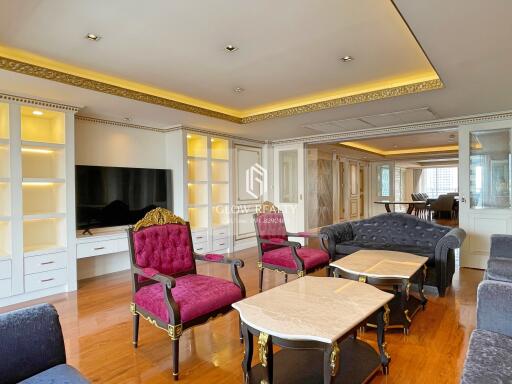 Elegant living room with ornate furniture and built-in shelving