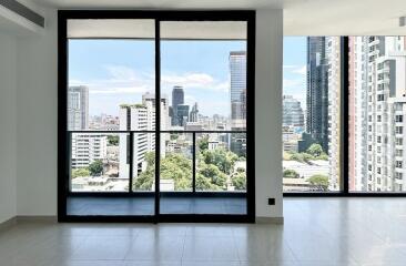 Modern living room with large glass doors offering a city view