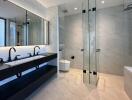 Modern bathroom with double sinks and glass shower enclosure