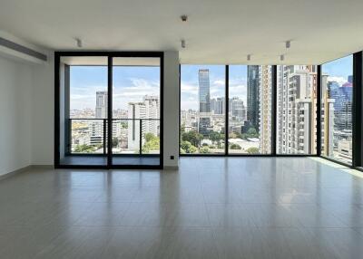 Spacious living room with large windows and city view