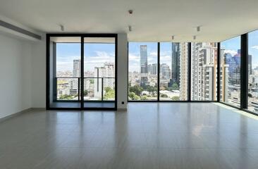 Spacious living room with large windows and city view