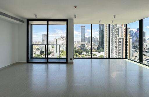 Spacious living room with large windows and city view