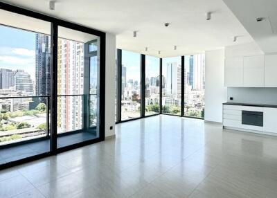 Spacious living area with large windows and city view