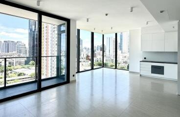 Spacious living area with large windows and city view