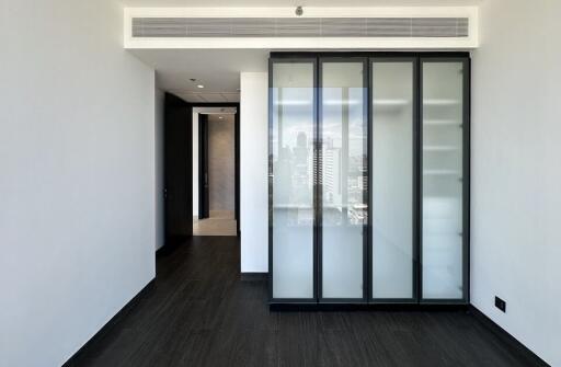 Bedroom with built-in closet and city view