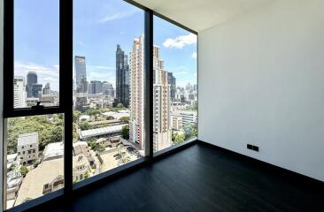 City view from an empty room with large windows