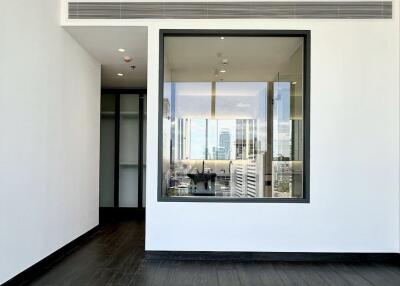 Modern living room with large window providing city view